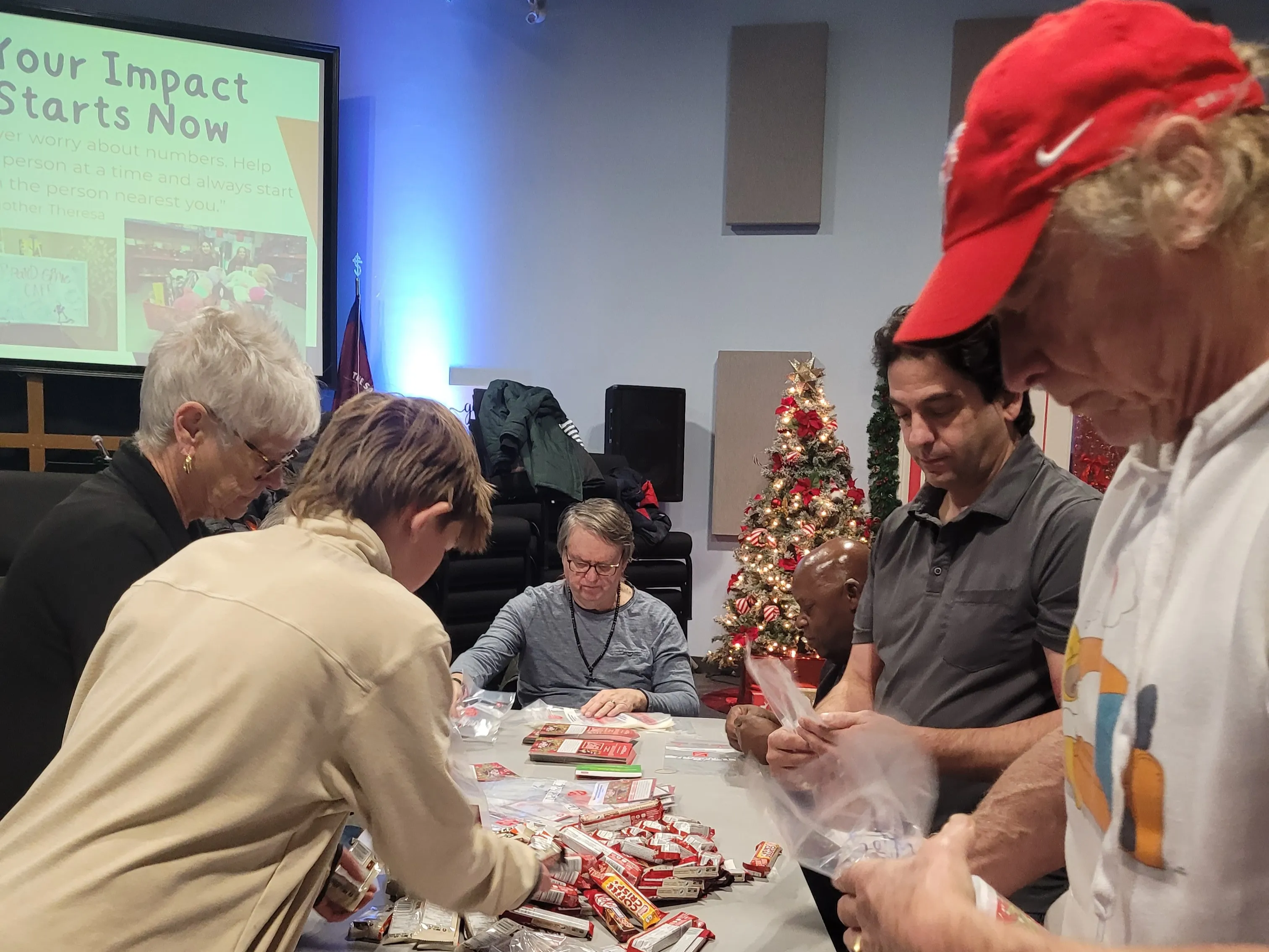 Volunteers sort food into bags to be delivered for Christmas