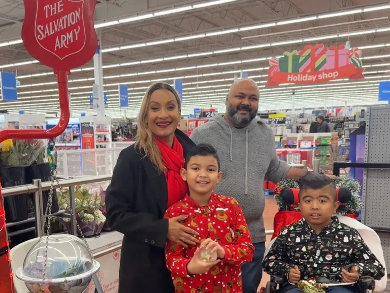A local family volunteers on a Salvation Army kettle at Walmart in Milton