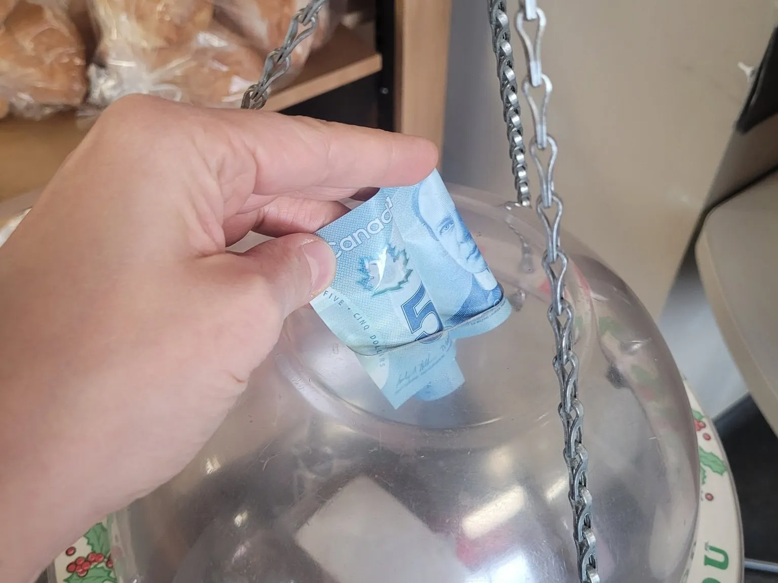 Money is donated to a Salvation Army kettle