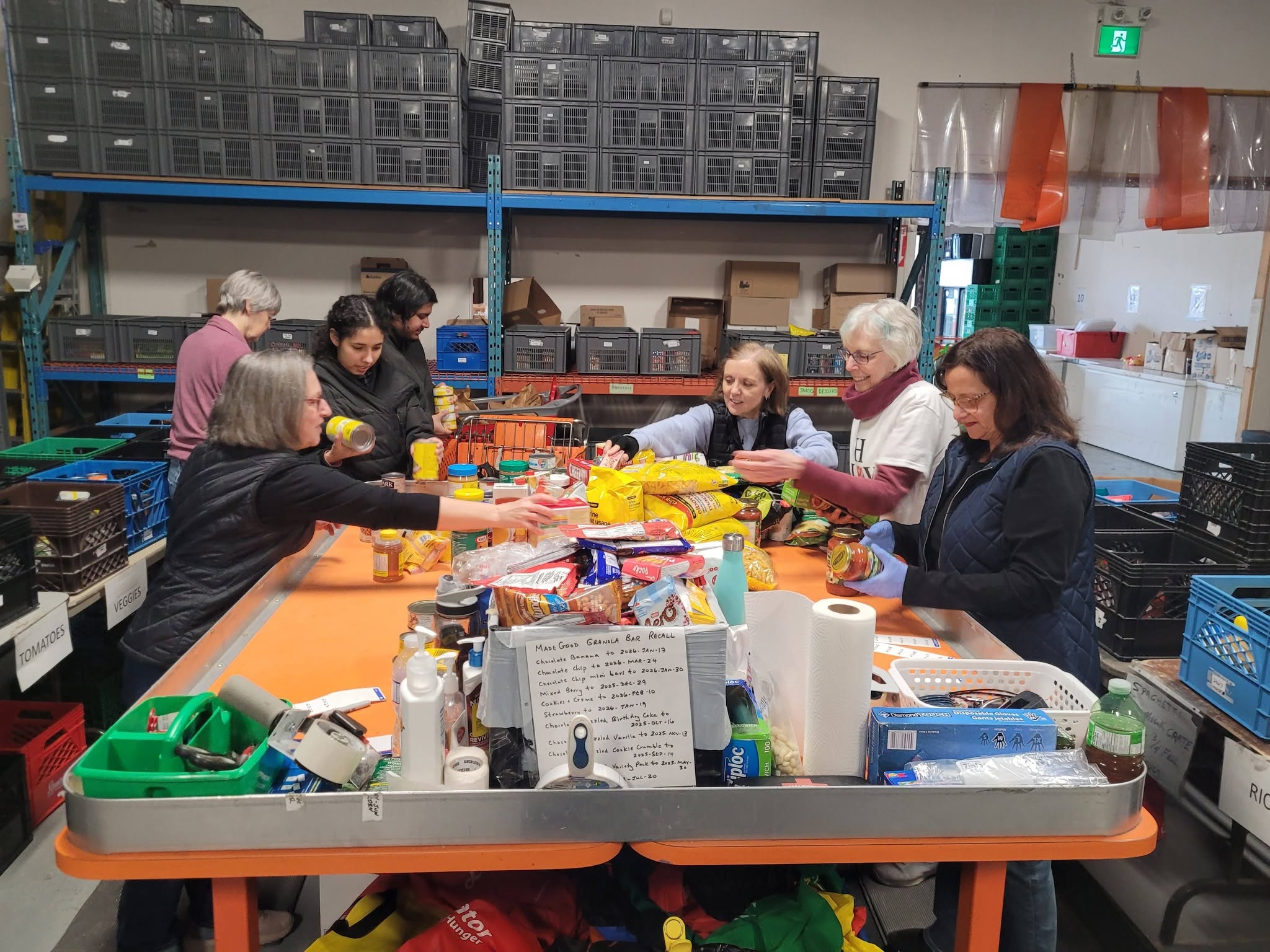 A group of women sort food in the warehouse at The Salvation Army Milton