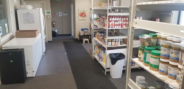 The food market area of Khi Food Bank where food sits on a shelf